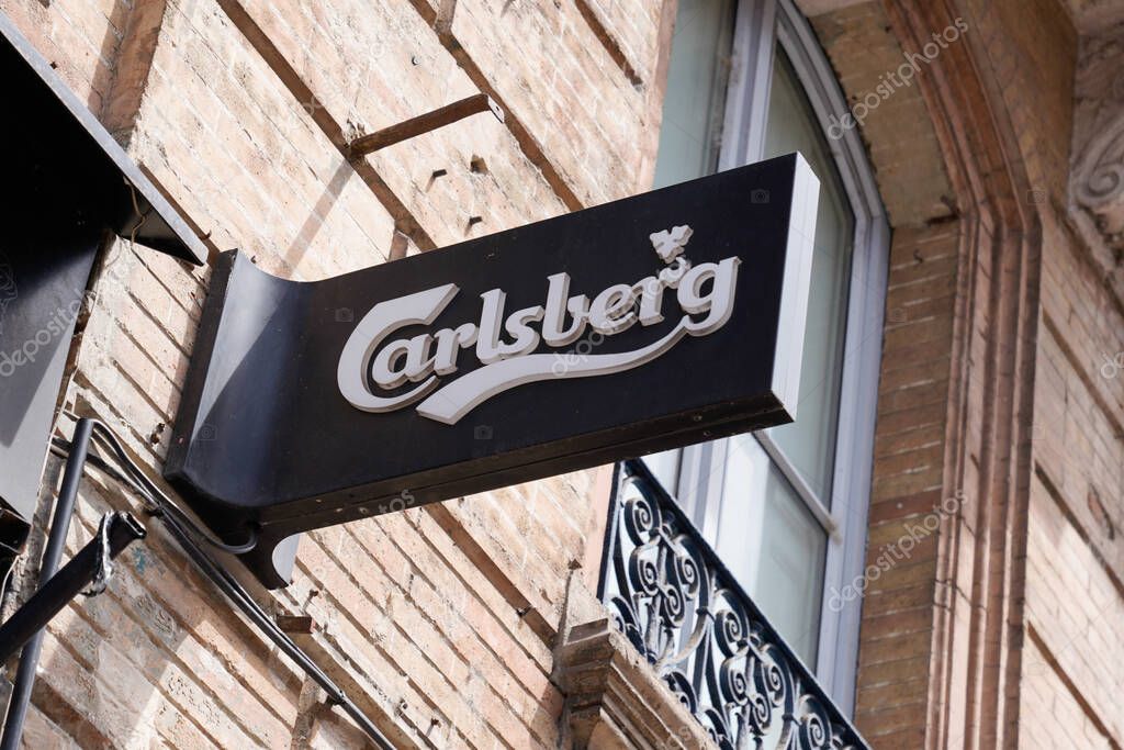 Bordeaux , Aquitaine France - 06 06 2021 : carlsberg beer text and sign logo front of bar brand on wall restaurant pub