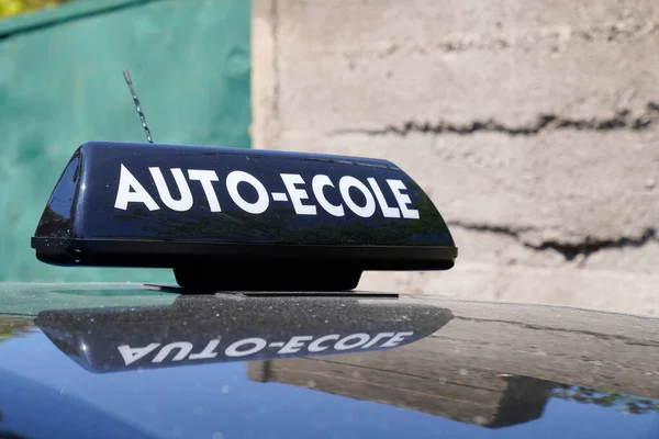 driving school means auto ecole text sign in french write on education learning car roof