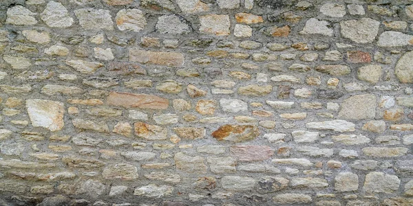 石の古い壁のヴィンテージテクスチャ背景パノラマヘッダーレンガは異なるサイズの石をサイド — ストック写真
