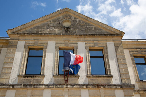 mairie means city hall in french town center with france and european flag on outdoor building wall facade
