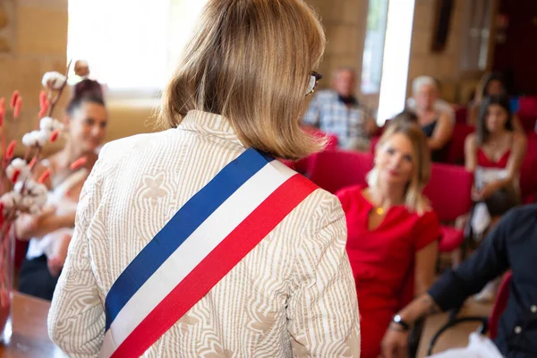 rear blonde woman french mayor of the city during an official celebration in france city hall