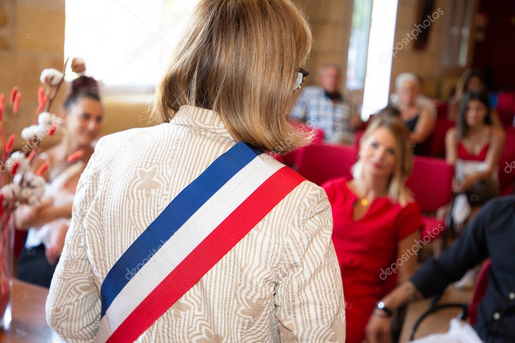 rear blonde woman french mayor of the city during an official celebration in france city hall