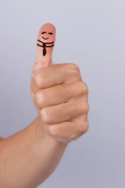 Thumbs up with a smiling face on it — Stock Photo, Image