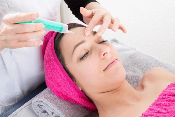 Woman gets an injection in her face — Stock Photo, Image