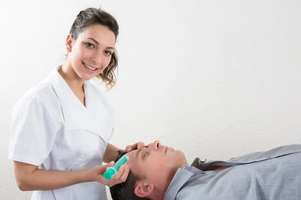 Mann bekommt Spritze ins Gesicht — Stockfoto