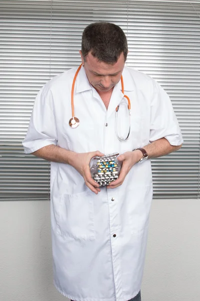 Portrait of cheerful doctor with several blister packs — Stock Photo, Image