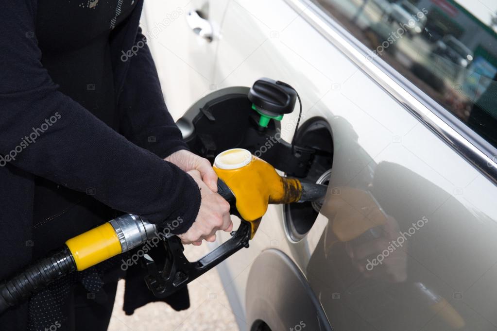Hands of woman refueling her car