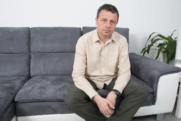 Happy  man is relaxing on sofa — Stock Photo, Image