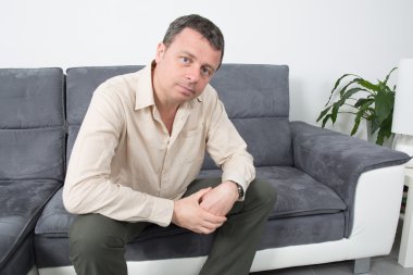 Evde koltukta oturan mutlu adam portresi