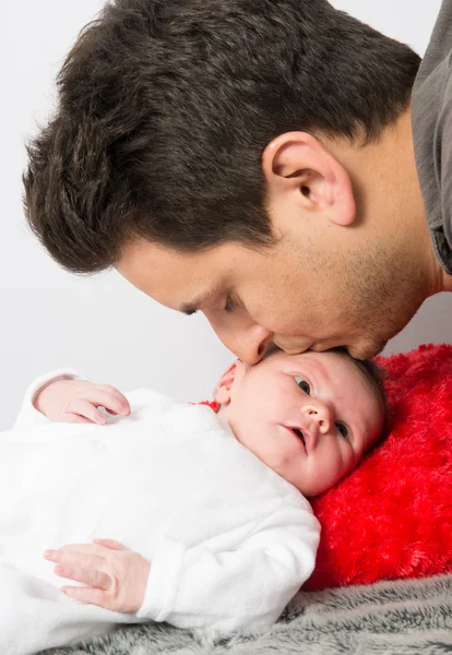 Father kissing his new born baby — Stock Photo, Image