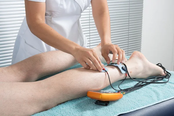 Man with electrostimulator electrodes on his body — Stock Photo, Image