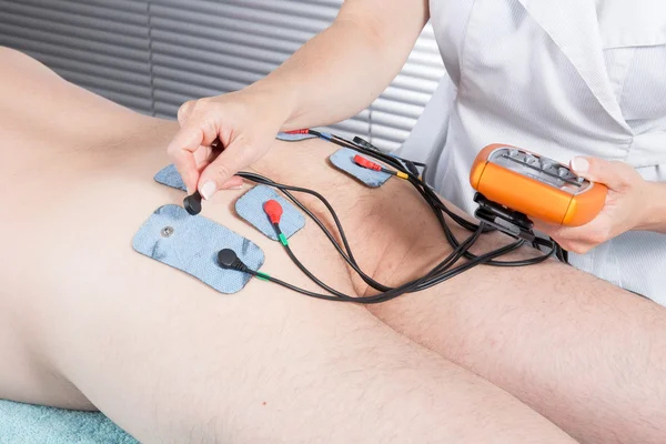 Man with electrostimulator electrodes — Stock Photo, Image