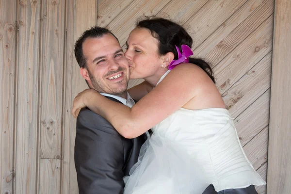 Matrimonio coppia back to back sotto lo sfondo di legno — Foto Stock