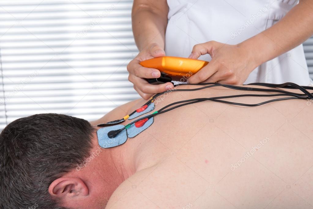 Man with electrostimulator electrodes on his Back