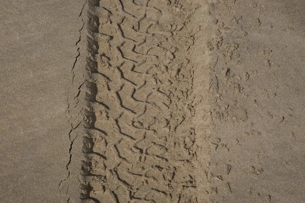 Stopy pneumatik v písku na pláži... — Stock fotografie