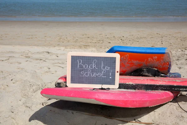 Back to school sign on the beach sand — Stock Photo, Image