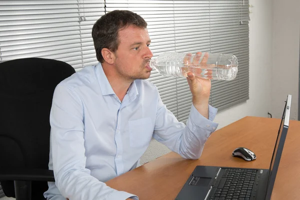 Obchodní muž pitnou vodu s lahví — Stock fotografie