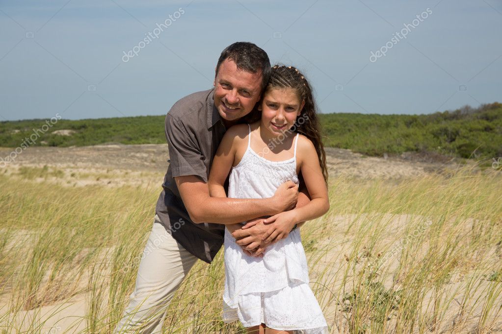 Happy father and his sweet little daughter at beach.