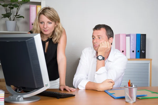 Business team, a boss and his secretary at office — Stock Photo, Image