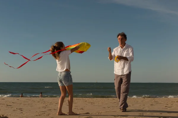 Two Generation Family Having Fun On Beach