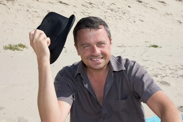 Handsome man with a hat looking at the camera — Stock Photo, Image