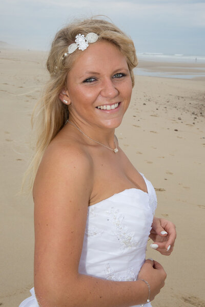 A beautiful bride with her wedding dress at the beach