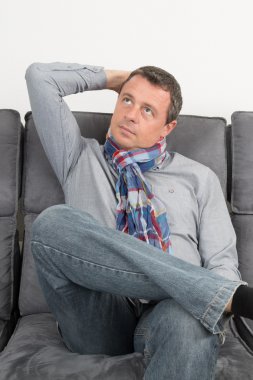 Evde onun kanepede oturan adam