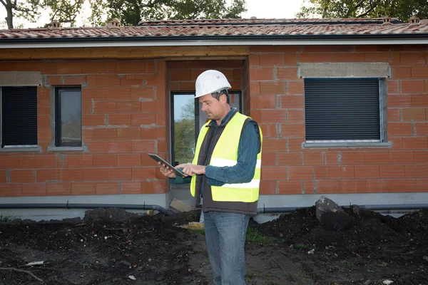 Architect cheking house under construction — Stock Photo, Image