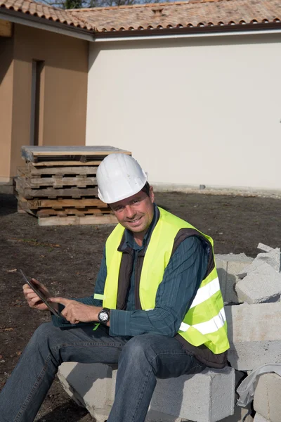 Manager using digital tablet on construction site — Stock Photo, Image