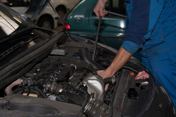 Auto mecânico verificando óleo. Serviço de reparação automóvel . — Fotografia de Stock