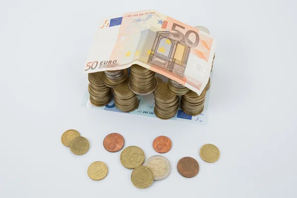 Model of house with coins isolated with white — Stock Photo, Image