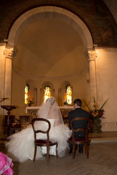 Задняя часть невесты и жениха в церкви во время свадебной церемонии — стоковое фото