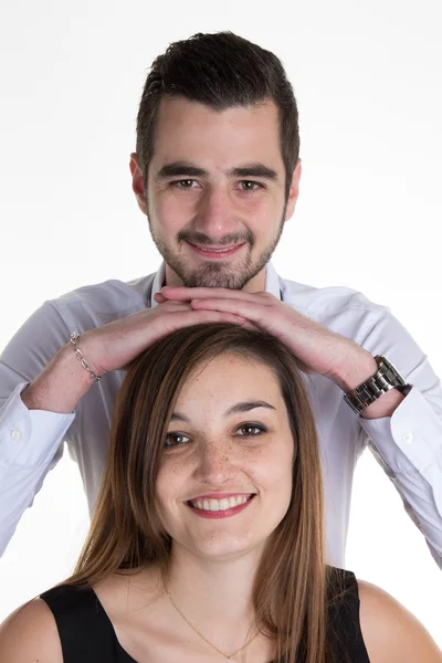 Atractiva pareja en ropa a juego sonriendo a la cámara en blanco —  Fotos de Stock