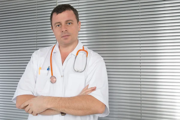 Frontal portrait of doctor with stethoscope with arms crossed — Stock Photo, Image