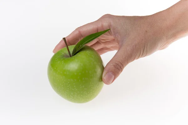 Mano de mujer sosteniendo manzana verde, aislada sobre fondo blanco — Foto de Stock