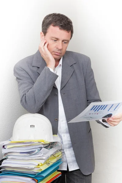 Man holding a document with a stack of document — Stock Photo, Image