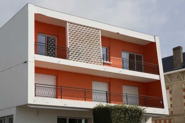 Detail of modern apartments with balconies and red walls — Stock Photo, Image