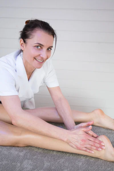 A esteticista que massajando o pé de seu paciente — Fotografia de Stock