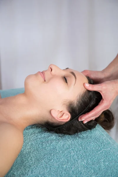 Happy  beautiful brunette woman taking head massage — Stock Photo, Image