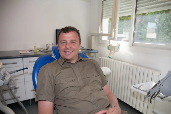 Happy and smiling man waiting for a dental exam