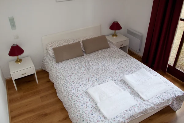 Двомісне ліжко в спальні з настільною лампою біля нього — стокове фото