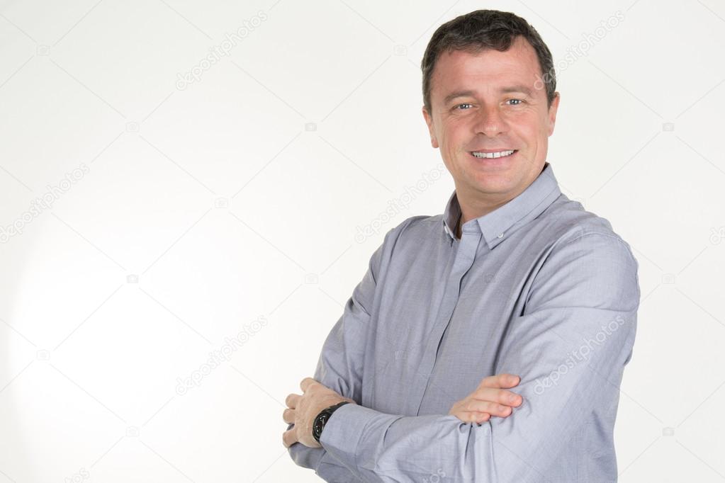 Casual businessman standing arms crossed, smiling