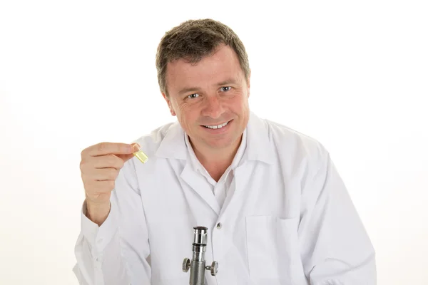 Smiling Scientific researcher sitting at laboratory desk — Stock Photo, Image