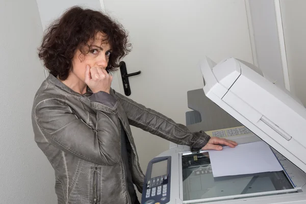 Business woman having trouble with copy machine