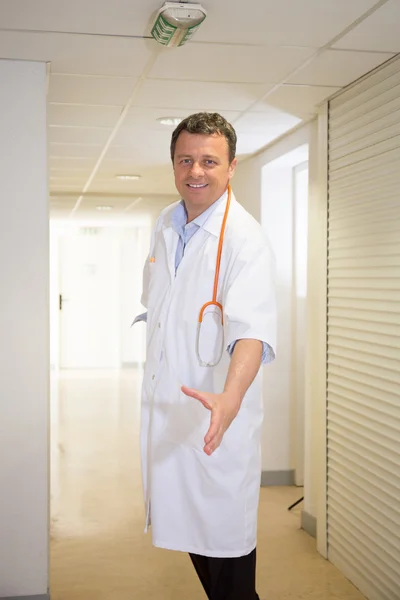 Friendly male doctor with open hand ready for hugging — Stock Photo, Image