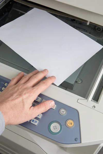 Businessman working with a printer in the office — Stock Photo, Image