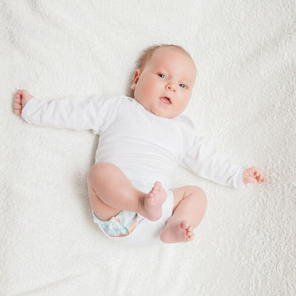 Newborn baby in white romper 