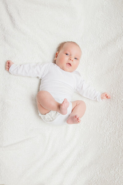 Newborn baby in white romper