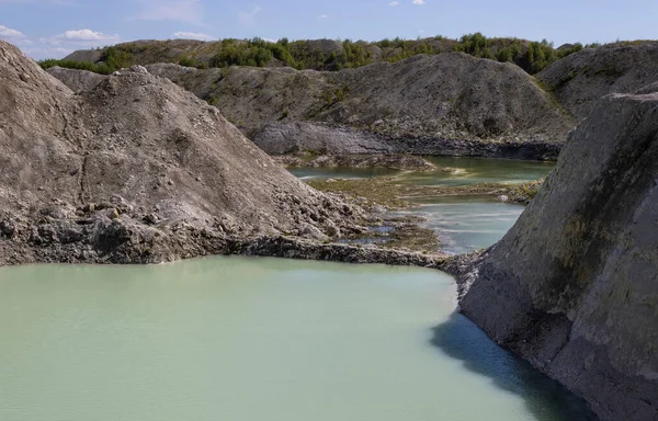 natural water at the foot of the grassy old and new chalk quarries landscape