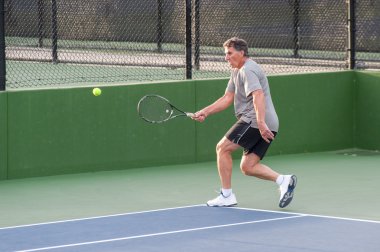 Tenis oyuncusu için topu almak hızlı